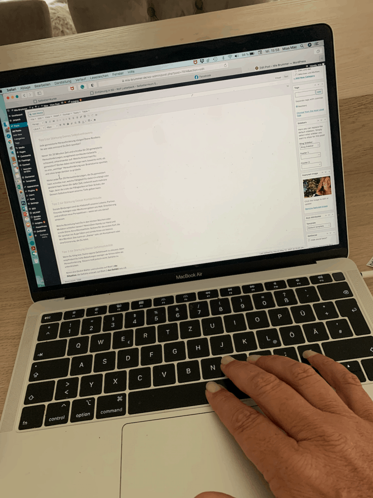 ein Macbook mit Fingern aus der Tastatur